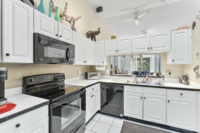 kitchen with a sink, black appliances, white cabinets, and light tile patterned floors