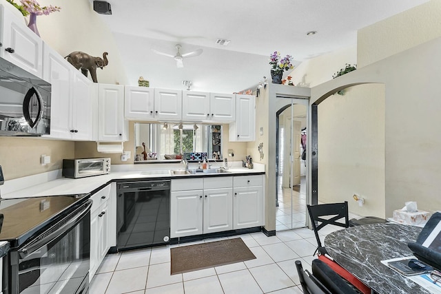 kitchen featuring visible vents, arched walkways, a sink, black appliances, and light countertops