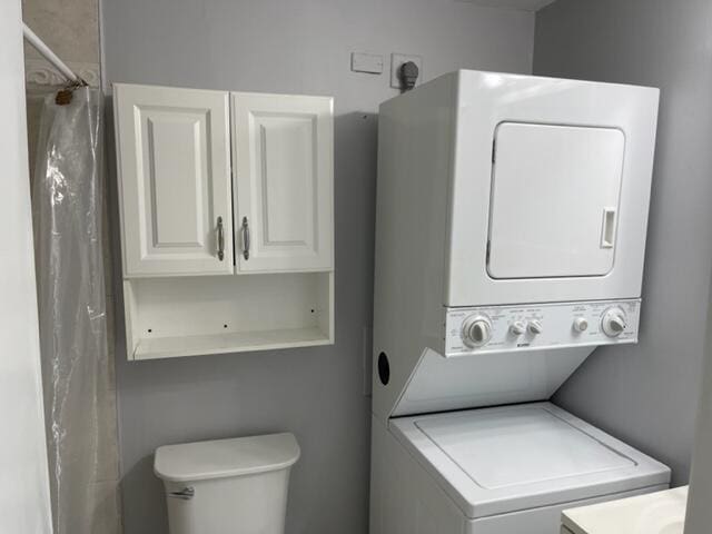 laundry room with laundry area and stacked washing maching and dryer