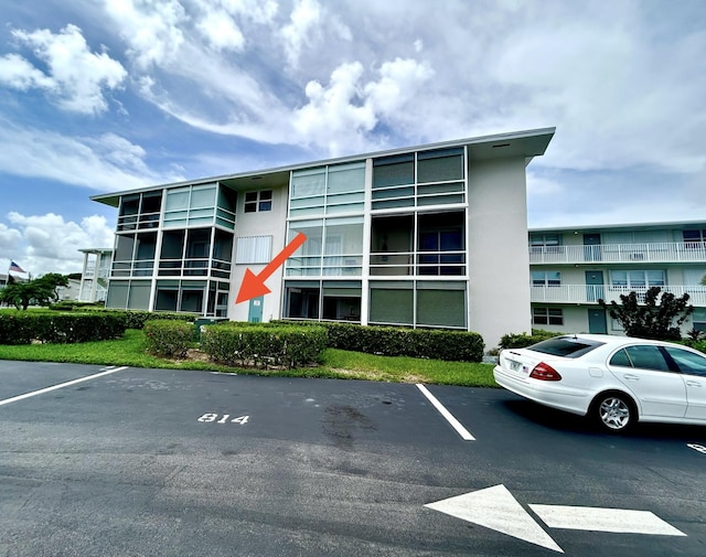 view of building exterior with uncovered parking