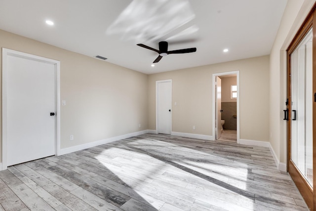 unfurnished bedroom with light wood finished floors, visible vents, baseboards, recessed lighting, and ensuite bathroom