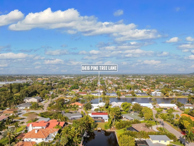 drone / aerial view with a residential view and a water view