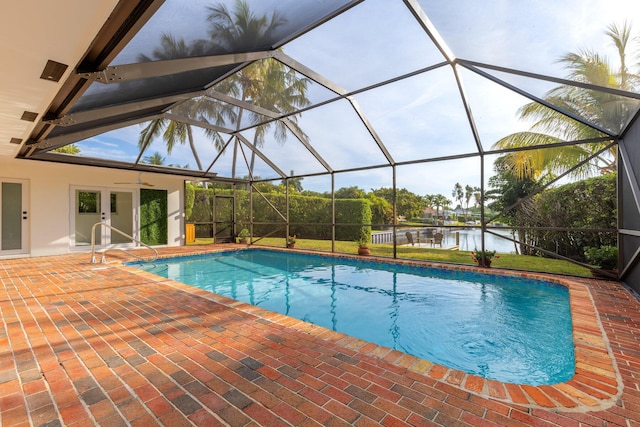 pool with a patio, a ceiling fan, a water view, and a lanai