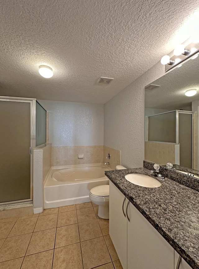 bathroom featuring tile patterned floors, visible vents, a garden tub, a shower stall, and a textured wall