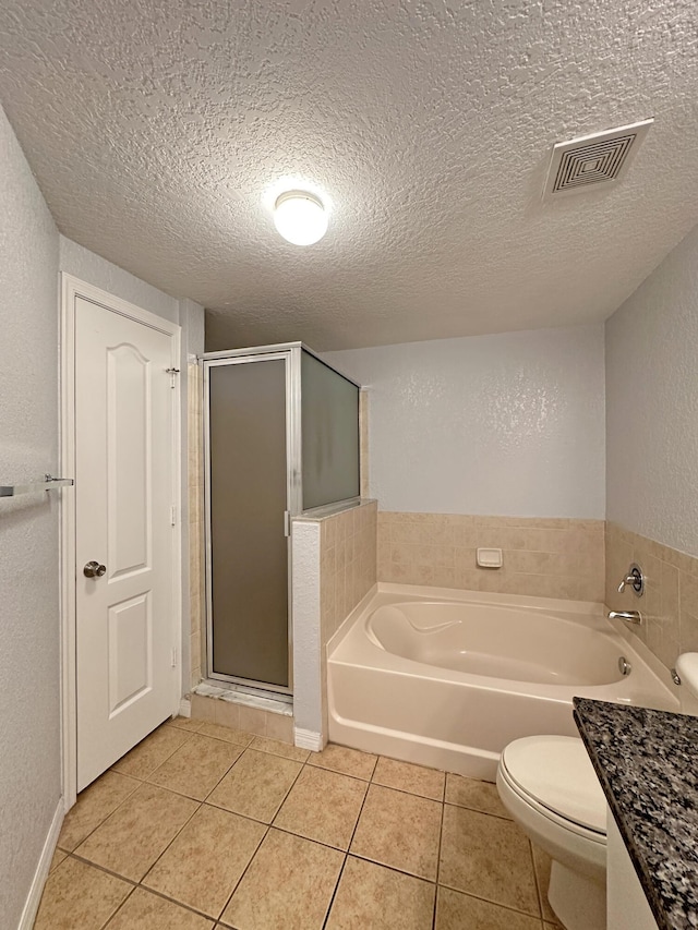 full bath with visible vents, a stall shower, tile patterned flooring, a textured ceiling, and a garden tub