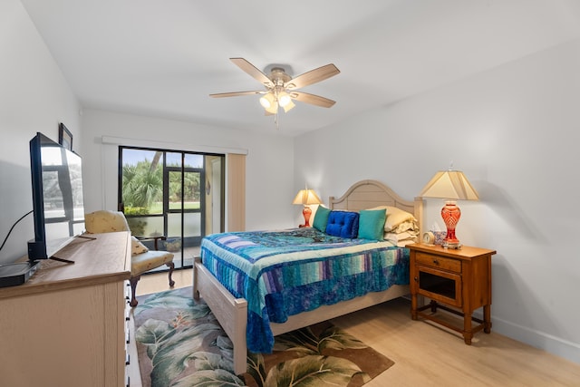 bedroom with baseboards, wood finished floors, a ceiling fan, and access to outside