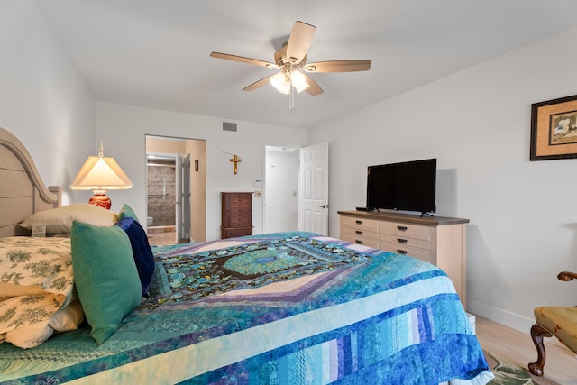 bedroom with visible vents, a ceiling fan, connected bathroom, light wood-style floors, and baseboards