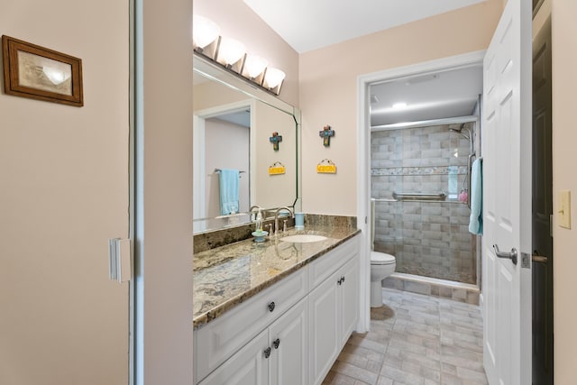 bathroom with vanity, toilet, visible vents, and a stall shower