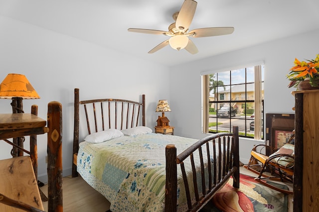 bedroom featuring baseboards, a ceiling fan, and wood finished floors