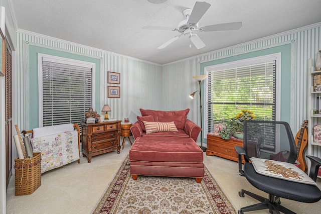 carpeted bedroom with a textured ceiling, ceiling fan, and ornamental molding