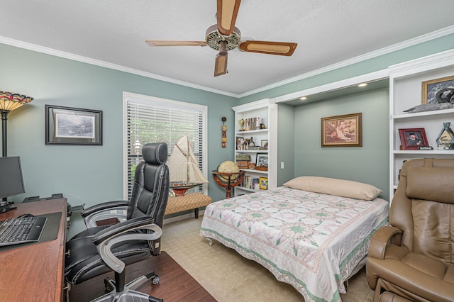 bedroom featuring ceiling fan, crown molding, wood finished floors, and a textured ceiling