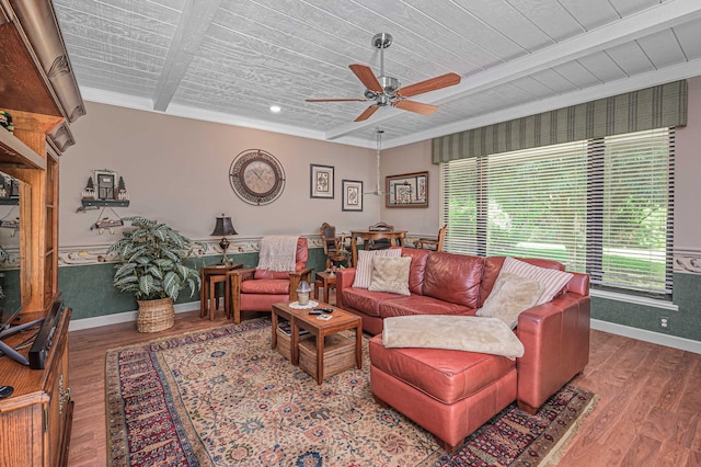 living room with ceiling fan, baseboards, beam ceiling, and wood finished floors