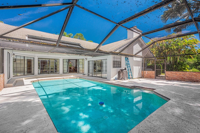 pool with a lanai and a patio area