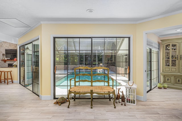 interior space featuring crown molding, wood finished floors, and baseboards