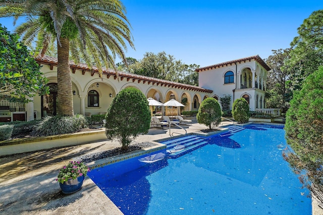 outdoor pool with a patio area