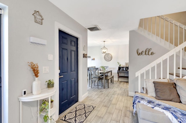 entryway with visible vents, stairway, baseboards, and wood tiled floor