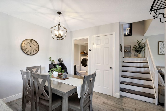 dining area featuring stairs, washer / clothes dryer, baseboards, and wood finish floors