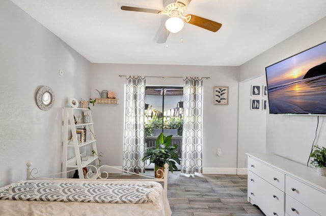 bedroom featuring ceiling fan, baseboards, and wood finished floors