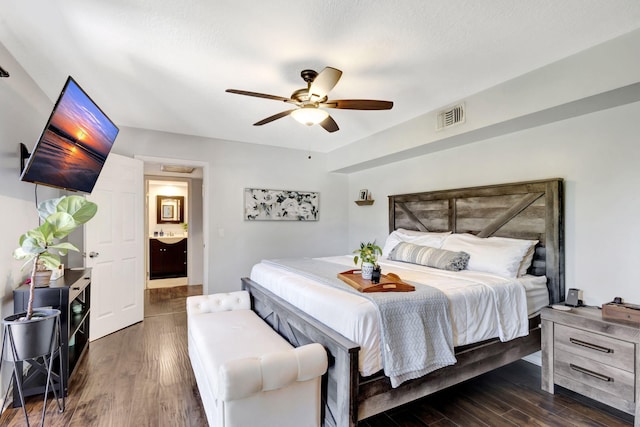 bedroom featuring wood finished floors, visible vents, and ceiling fan