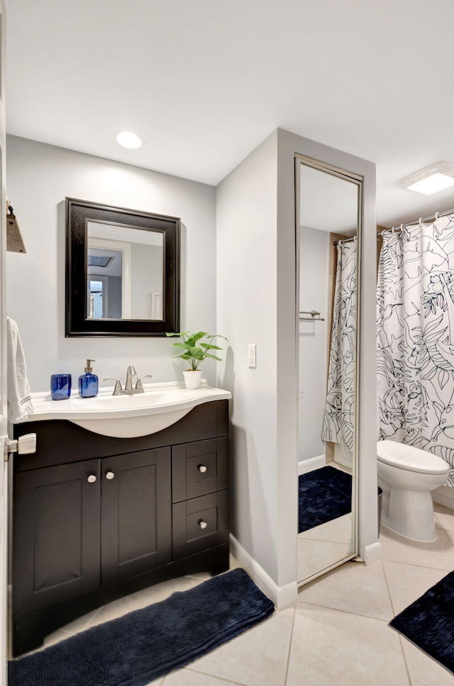 bathroom featuring vanity, baseboards, recessed lighting, tile patterned floors, and toilet