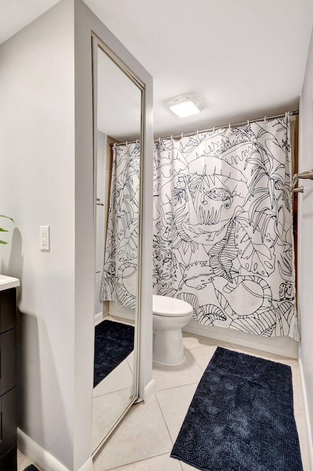 bathroom featuring curtained shower, toilet, vanity, and tile patterned flooring