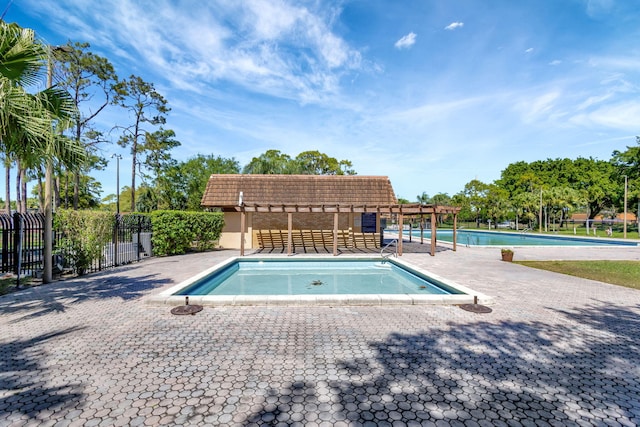 pool with fence and a pergola