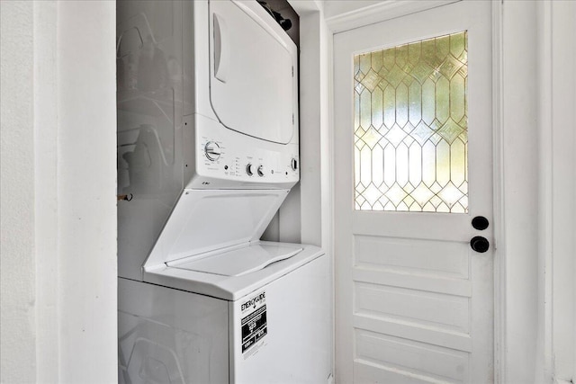 laundry area with stacked washer / drying machine and laundry area