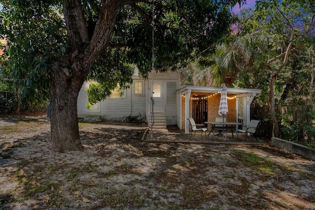 back of house featuring entry steps and a patio area