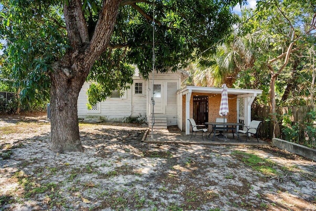 exterior space with entry steps, a patio, and fence