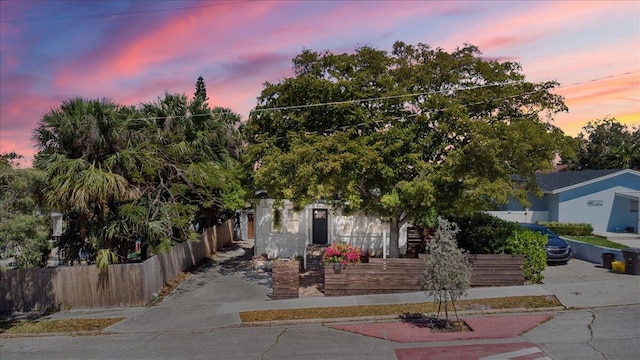 obstructed view of property featuring a fenced front yard