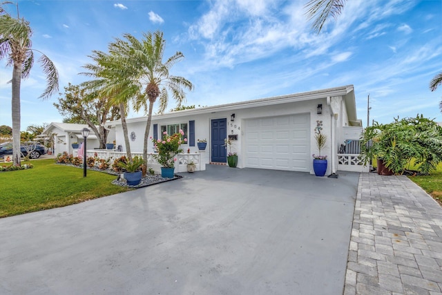 ranch-style house featuring concrete driveway, an attached garage, a front lawn, and stucco siding