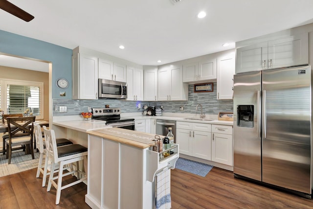 1504 SW 22nd Ave, Boynton Beach, FL 33426 - kitchen featuring light countertops, dark wood-type flooring, appliances with stainless steel finishes, and a sink