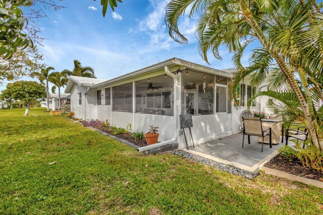 1504 SW 22nd Ave, Boynton Beach, FL 33426 - view of side of property featuring a yard, a patio area, and a sunroom