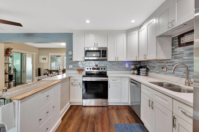 1504 SW 22nd Ave, Boynton Beach, FL 33426 - kitchen with a sink, appliances with stainless steel finishes, a peninsula, and light countertops