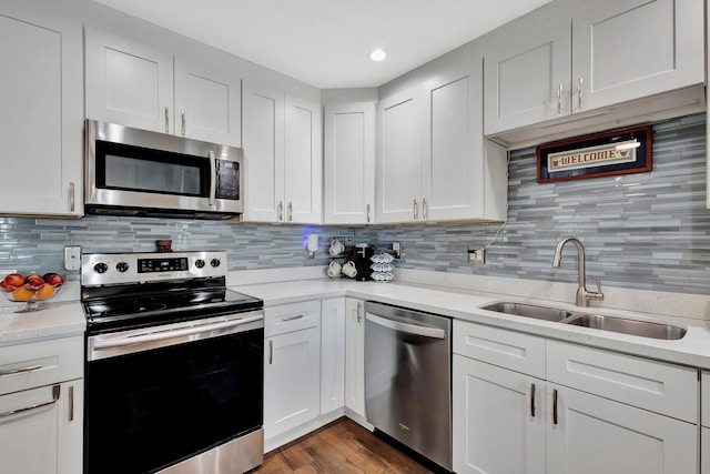 1504 SW 22nd Ave, Boynton Beach, FL 33426 - kitchen featuring a sink, tasteful backsplash, white cabinetry, and stainless steel appliances