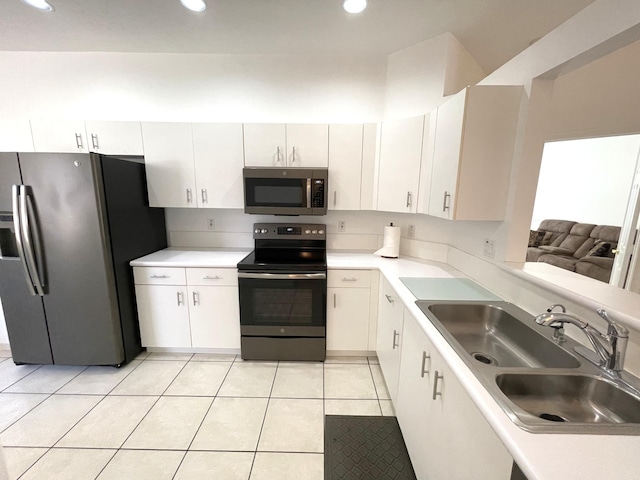 kitchen featuring light tile patterned floors, recessed lighting, a sink, light countertops, and appliances with stainless steel finishes