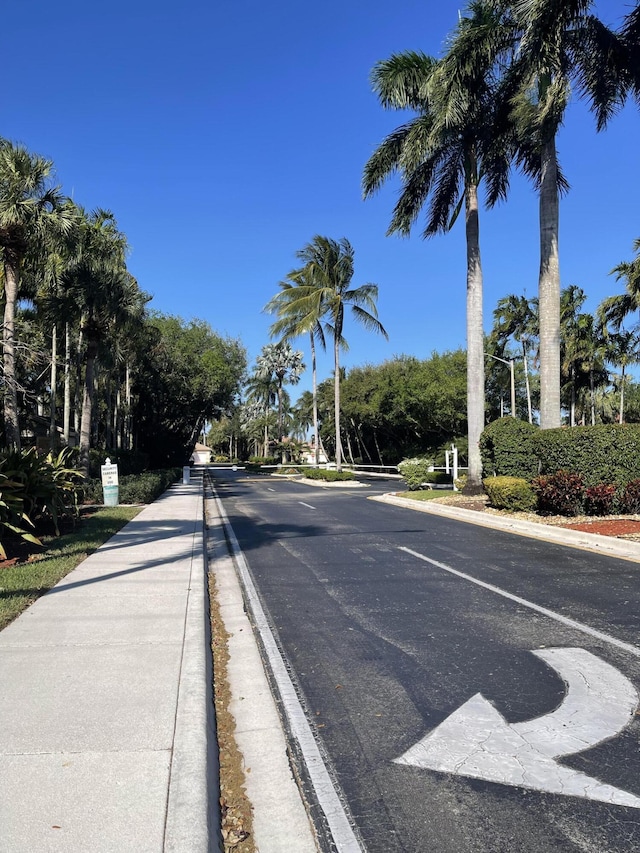 9675 Crescent View Dr N, Boynton Beach, FL 33437 - view of asphalt road featuring curbs and sidewalks
