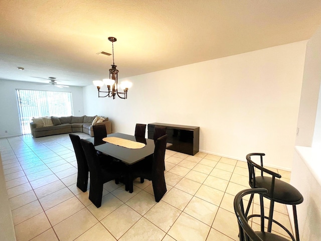 9675 Crescent View Dr N, Boynton Beach, FL 33437 - dining room with light tile patterned floors, a chandelier, and ceiling fan