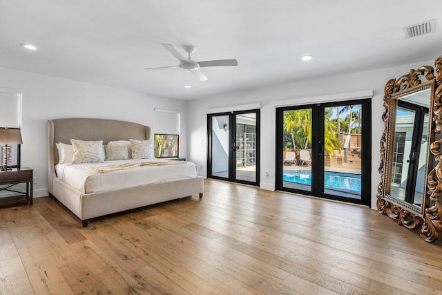 bedroom featuring french doors, visible vents, light wood-style flooring, and access to outside