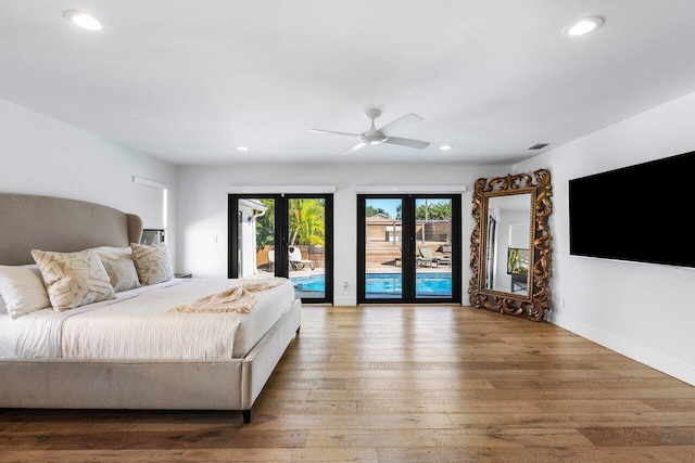 bedroom featuring wood finished floors, baseboards, recessed lighting, access to exterior, and french doors