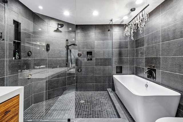 full bathroom with tile walls, a freestanding tub, recessed lighting, and tiled shower