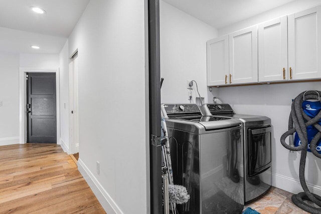 laundry area featuring baseboards, light wood finished floors, recessed lighting, cabinet space, and washer and dryer