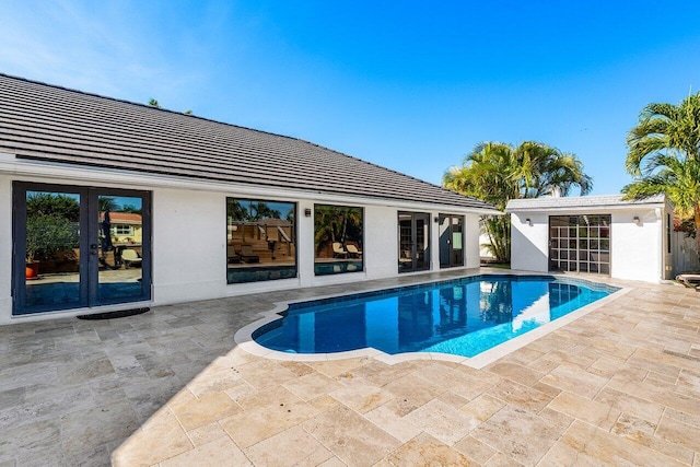 outdoor pool featuring a patio area and french doors