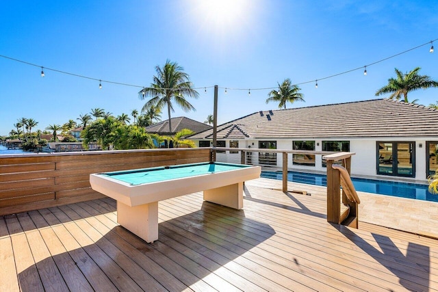 wooden terrace with a fenced in pool