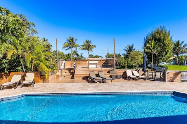 pool featuring a patio and fence