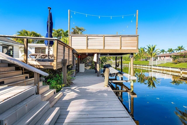 dock area with a water view and boat lift