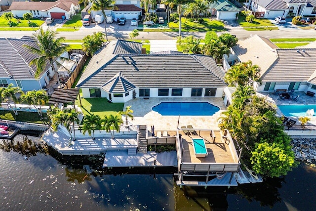 drone / aerial view featuring a residential view and a water view