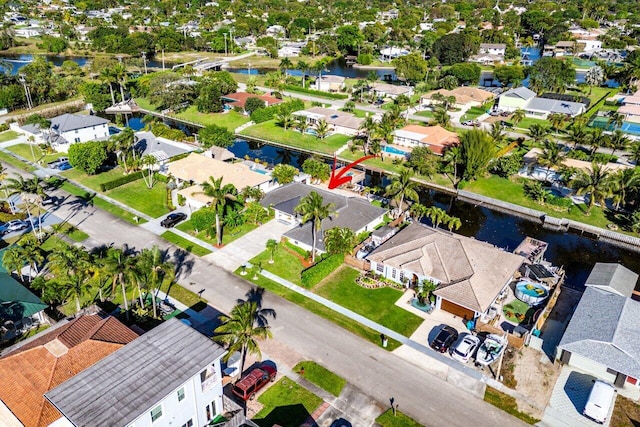 birds eye view of property with a residential view and a water view