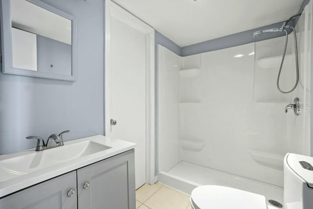 full bath with tile patterned flooring, vanity, toilet, and a shower