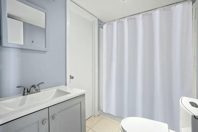 bathroom with tile patterned floors, toilet, and vanity